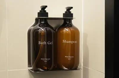 two bottles of soap are sitting on a shelf at Stylist Siamese Design House Steps To Chinatown - Self Check In in Bangkok