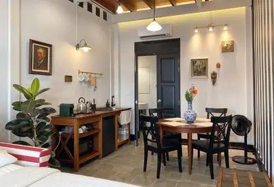 a living room with a table and chairs and a kitchen at Stylist Siamese Design House Steps To Chinatown - Self Check In in Bangkok