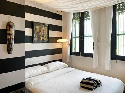 a bedroom with a black and white striped wall at Stylist Siamese Design House Steps To Chinatown - Self Check In in Bangkok