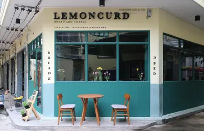 a table and chairs in front of a store at Lemoncurd Bread and Coffee in Bangkok