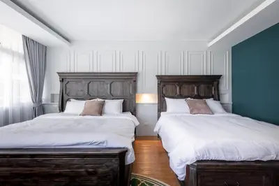 two beds sitting next to each other in a bedroom at Lemoncurd Bread and Coffee in Bangkok