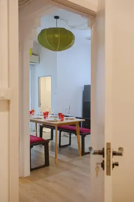 a dining room with a table and a green ceiling at 2 BR Sleeps6 I City Center Silom in Bangkok