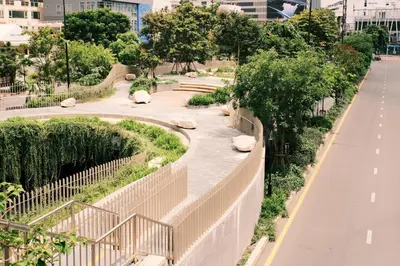 a walkway in a park with rocks and trees at 2 BR Sleeps6 I City Center Silom in Bangkok