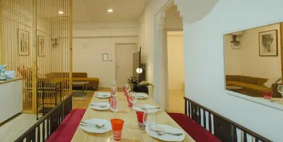 a table with plates and glasses on top of it at 2 BR Sleeps6 I City Center Silom in Bangkok