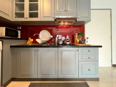 a kitchen with white cabinets and a sink at Stylish 2BR City View - BTS St.Louis - Ultra Fast Wifi in Bangkok