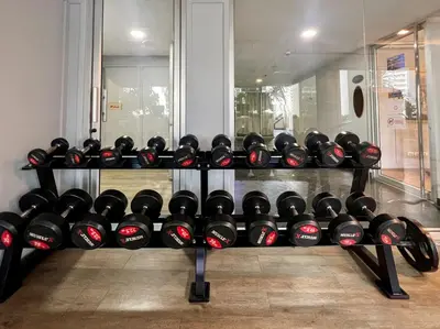 a rack of dumbbells in a gym at Stylish 2BR City View - BTS St.Louis - Ultra Fast Wifi in Bangkok