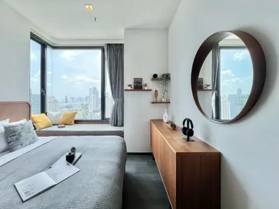 a hotel room with a bed and a mirror at Urban Chic Living - 1BR - Ultra Fast WiFi - BTS Asoke in Bangkok