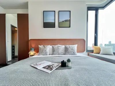 a bedroom with a bed with a magazine on it at Urban Chic Living - 1BR - Ultra Fast WiFi - BTS Asoke in Bangkok