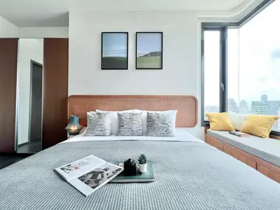 a bedroom with a bed with a magazine on it at Urban Chic Living - 1BR - Ultra Fast WiFi - BTS Asoke in Bangkok