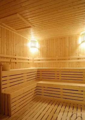 a large wooden sauna with two benches and lights at คอนโดศุภาลัยเวลลิงตัน2 in Bangkok