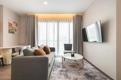a living room with a couch and a table at The Rich Grand Residence Sukhumvit in Bangkok