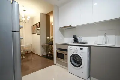 a kitchen with a washing machine in a kitchen at The Rich Grand Residence Sukhumvit in Bangkok