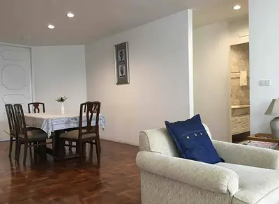 a living room with a table and a couch at Trinity City View 3BR Spacious Family Silom in Bangkok