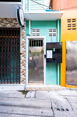 a front door of a building with a pay meter at xxGO INN The Giant Swing - เสาชิงช้า in Bangkok