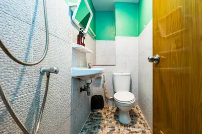 a bathroom with a toilet and a sink at xxGO INN The Giant Swing - เสาชิงช้า in Bangkok