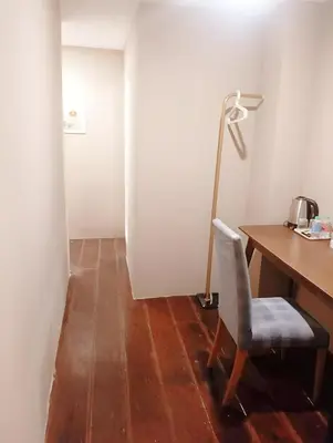 a room with a desk and a chair and a lamp at xx Rest Inn Yaowarat Bangkok - เรสอินน์ เยาวราช in Samphanthawong