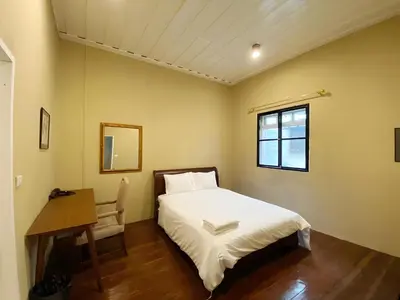 a bedroom with a bed and a desk and a window at xx Rest Inn Yaowarat Bangkok - เรสอินน์ เยาวราช in Samphanthawong