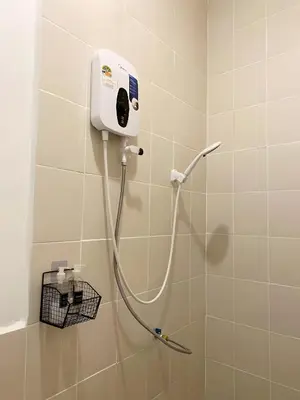 a shower in a bathroom with a hose on the wall at xx Rest Inn Yaowarat Bangkok - เรสอินน์ เยาวราช in Samphanthawong