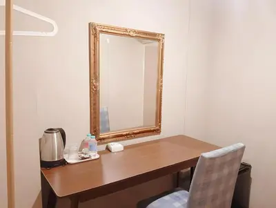 a mirror sitting on top of a wooden desk at xx Rest Inn Yaowarat Bangkok - เรสอินน์ เยาวราช in Samphanthawong