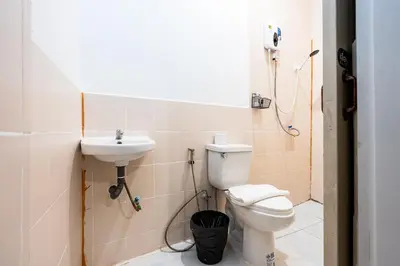 a bathroom with a toilet and a sink at xx Rest Inn Yaowarat Bangkok - เรสอินน์ เยาวราช in Samphanthawong