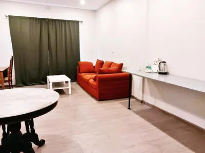 a living room with a couch and a table at XX Hidden Dragon Yaowarat Road in Bangkok