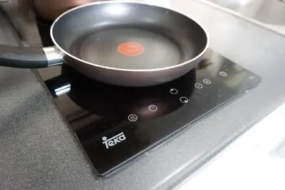 a pot sitting on top of a stove at Central next to Shopping 1 Bedroom Condo - 2 Min to BTS Asok and Terminal 21 in Bangkok