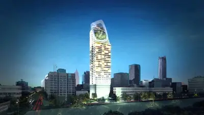 a tall building with a clock on it in a city at 1 Bedroom at Q Chidlom in Bangkok