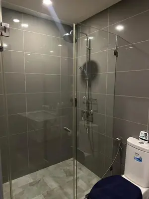 a bathroom with a glass shower with a toilet at 1 Bedroom at Q Chidlom in Bangkok