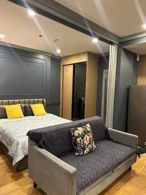 a bedroom with a bed and a couch at 1 Bedroom at Q Chidlom in Bangkok