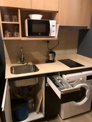 a small kitchen with a sink and a microwave at 1 Bedroom at Q Chidlom in Bangkok