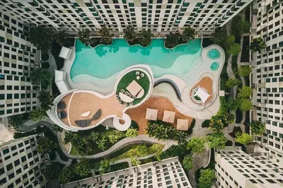 an aerial view of a building with a swimming pool at Resort style family room near BTS Bearing in Ban Khlong Samrong