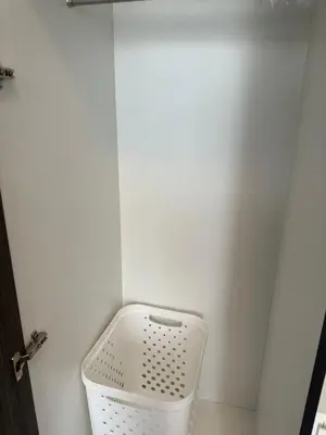 a corner of a bathroom with a white wall at Resort style family room near BTS Bearing in Ban Khlong Samrong