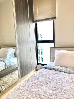 a bedroom with a bed and a large mirror at Resort style family room near BTS Bearing in Ban Khlong Samrong