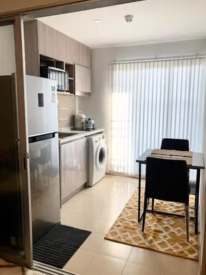 a kitchen with a table and a laundry room at Resort Style room Ellio Monthly Available in Bangkok