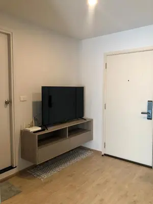 a living room with a flat screen tv on a entertainment center at Resort Style room Ellio Monthly Available in Bangkok