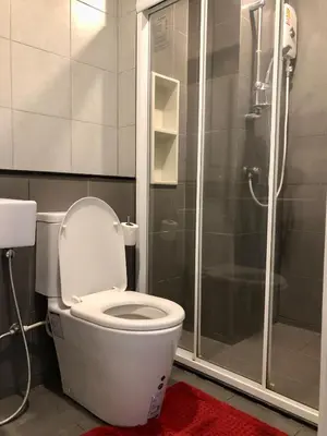 a bathroom with a toilet and a shower at Resort Style room Ellio Monthly Available in Bangkok