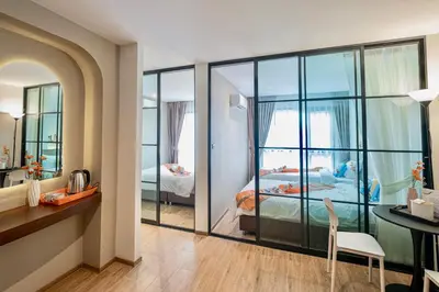 a bedroom with a view of a bed and a desk at Metro Hotel Phahonyothin 35 in Bangkok