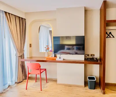 a kitchen with a desk and a red chair at Metro Hotel Phahonyothin 35 in Bangkok