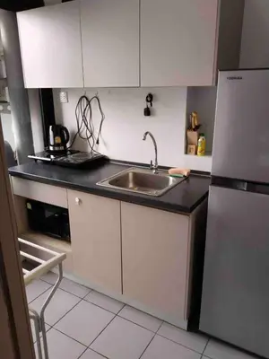 a kitchen with a sink and a refrigerator at Great facilities n River view n Local in Ban Sai Ma