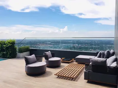 a patio with couches and a view of a city at Great facilities n River view n Local in Ban Sai Ma