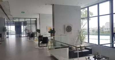 a lobby with a table and chairs in a building at The Rich Rama 9 Luxury Condos in Sathani Ban Hua Mak