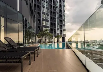 a view of a building with a swimming pool at The Rich Rama 9 Luxury Condos in Sathani Ban Hua Mak
