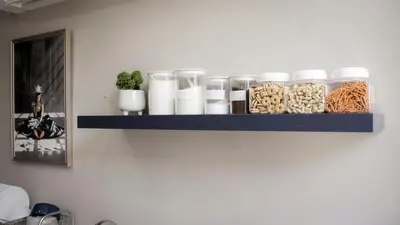 a shelf with jars and pasta on a wall at Poshtel 56 in Bangkok