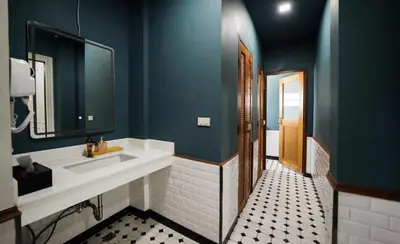 a bathroom with a sink and a mirror at Poshtel 56 in Bangkok