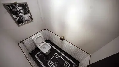 a small bathroom with a toilet in the corner at Poshtel 56 in Bangkok