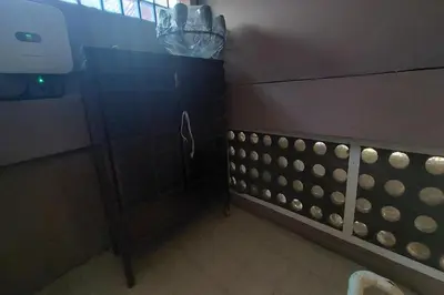 a bathroom with a black cabinet and a wall at Sukhum Sukhumvit-Onnut Guest House in Amphoe Phra Khanong