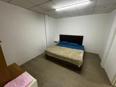 a small room with a bed in a room at Sukhum Sukhumvit-Onnut Guest House in Amphoe Phra Khanong