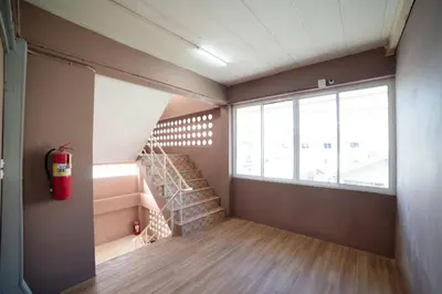 a room with a fire hydrant and a staircase at Sukhum Sukhumvit-Onnut Guest House in Amphoe Phra Khanong