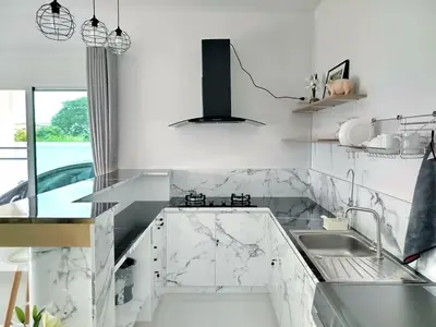 a kitchen with white marble countertops and a sink at Hidden Gems Residence in Ban Sala Daeng