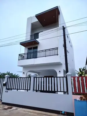 a white apartment building with a balcony at Hidden Gems Residence in Ban Sala Daeng